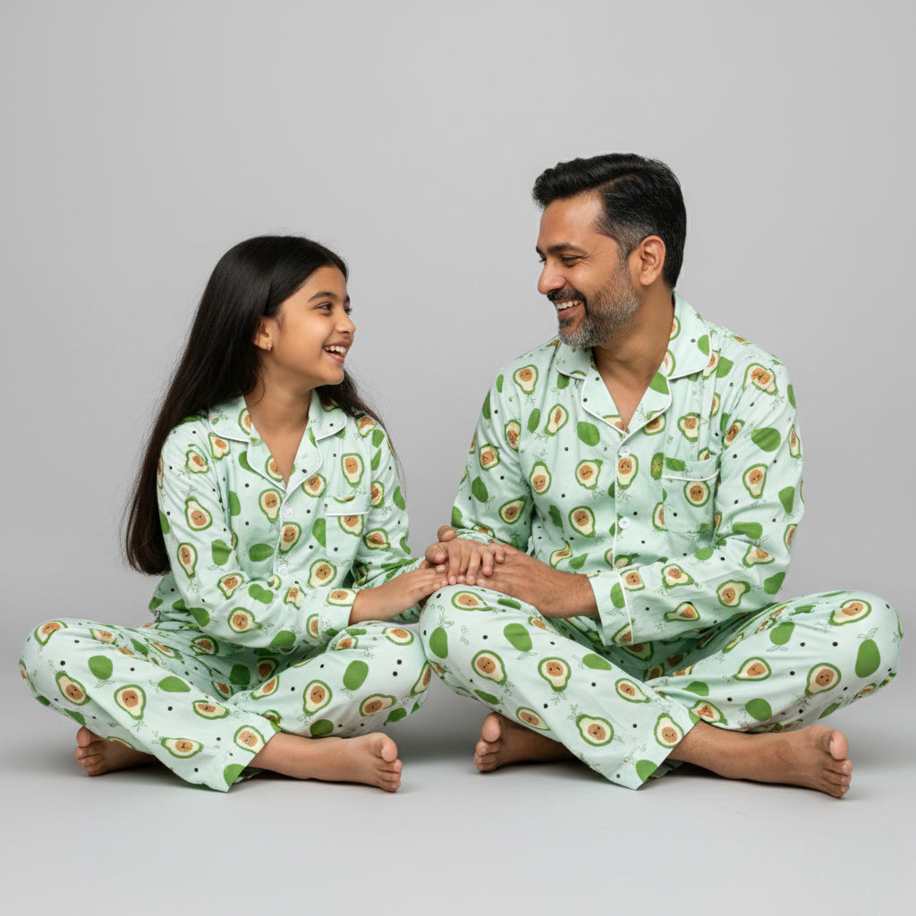 Father and daughter wearing avocado print matching pajamas, fun green coordinated design.