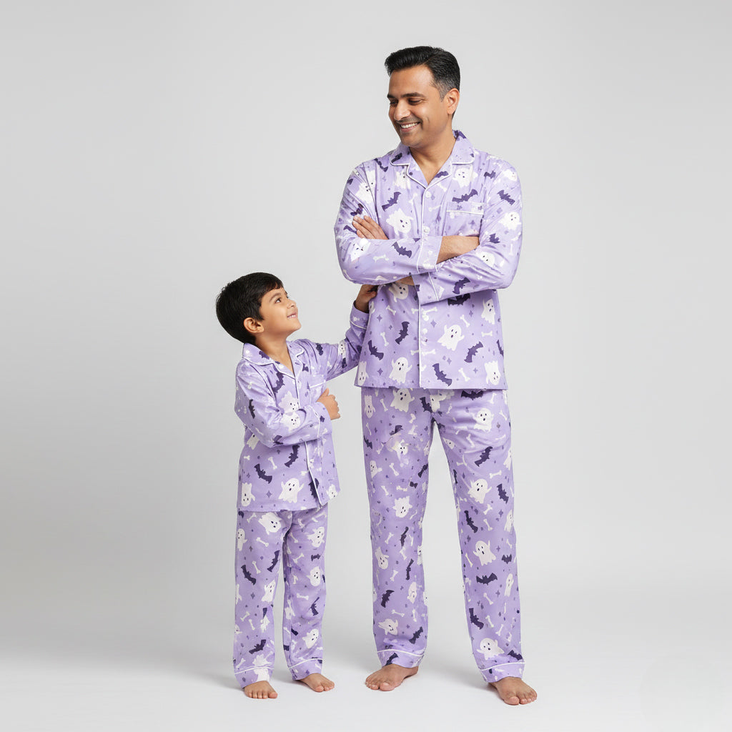 Father and son wearing Boo Crew matching pajama set, purple ghost-themed coordinated nightwear.