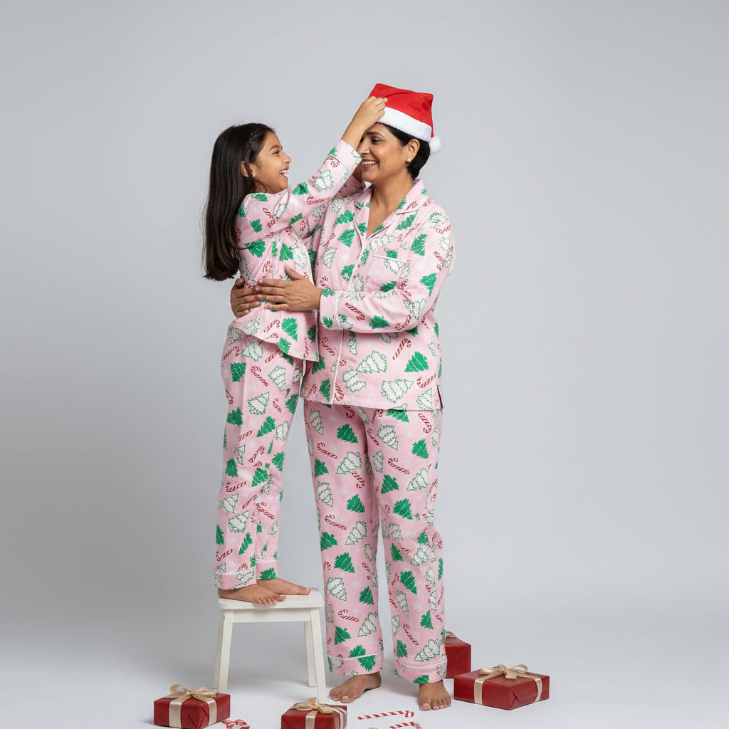 Mother and daughter in candy cane matching pajamas, festive coordinated Christmas print.