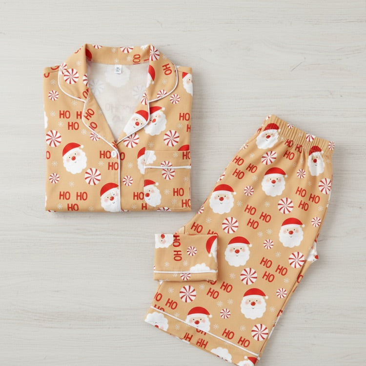 Christmas-themed pajama set with Santa Claus and 'HO HO HO' text on a light background