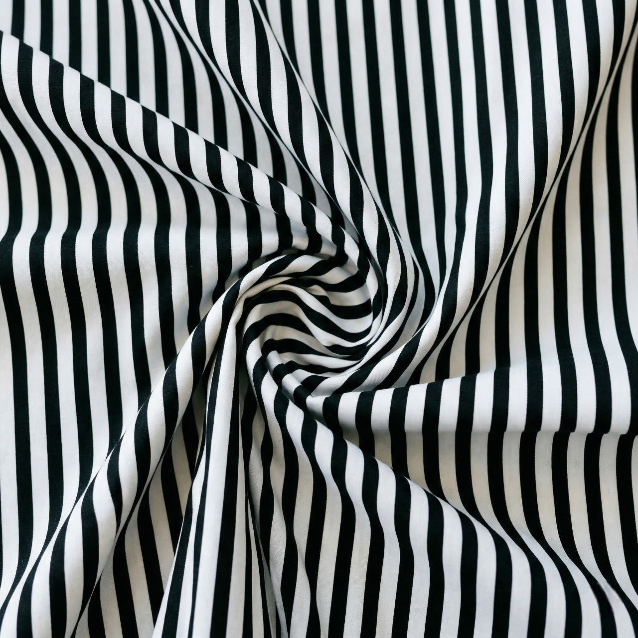 Black and white striped fabric in a swirl pattern