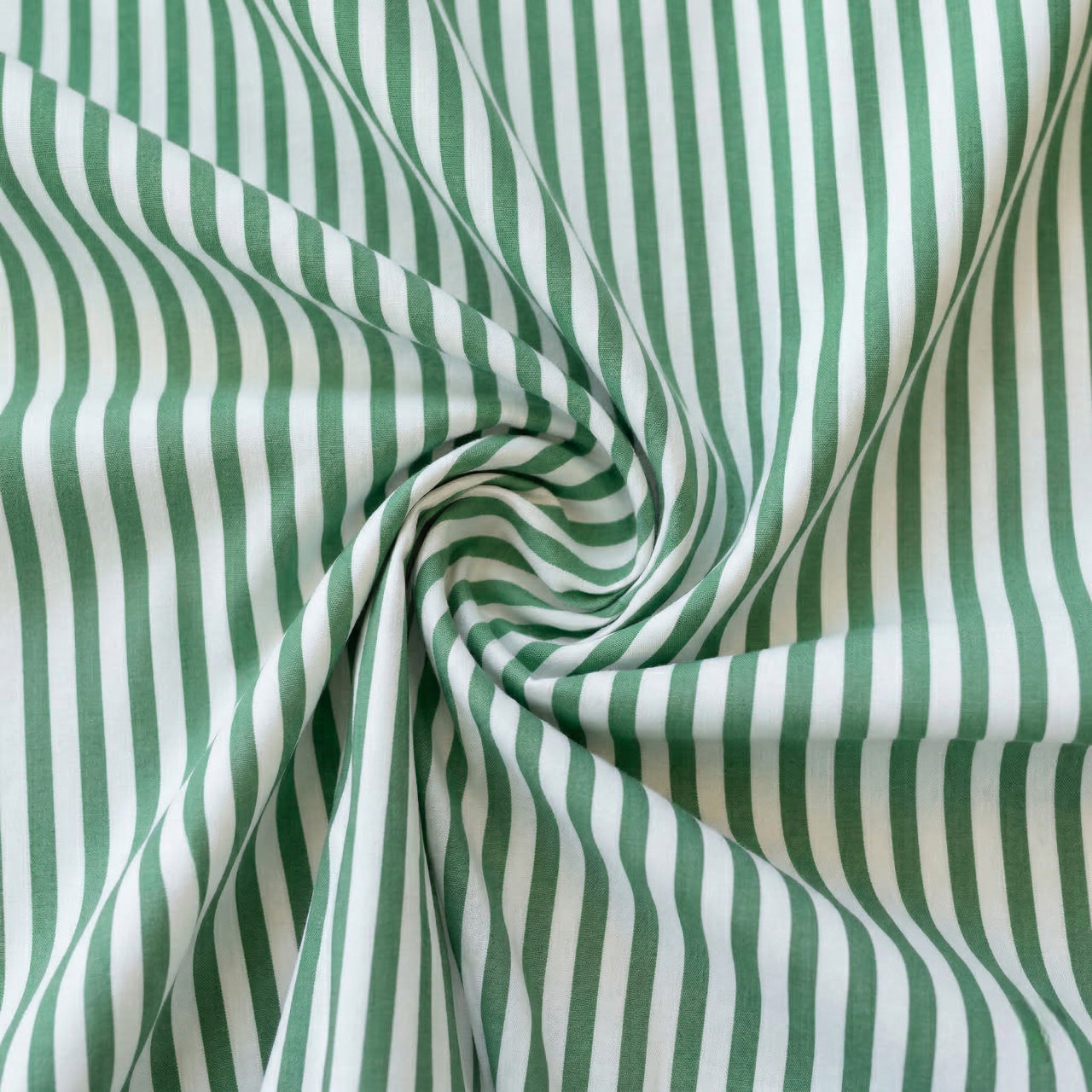Green and white striped fabric in a swirl pattern
