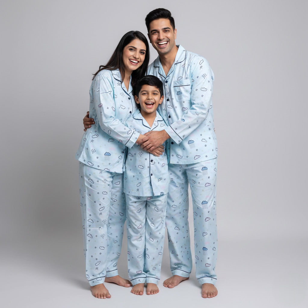 Family posing in clouds-in-the-sky matching pajamas, soft blue coordinated set.