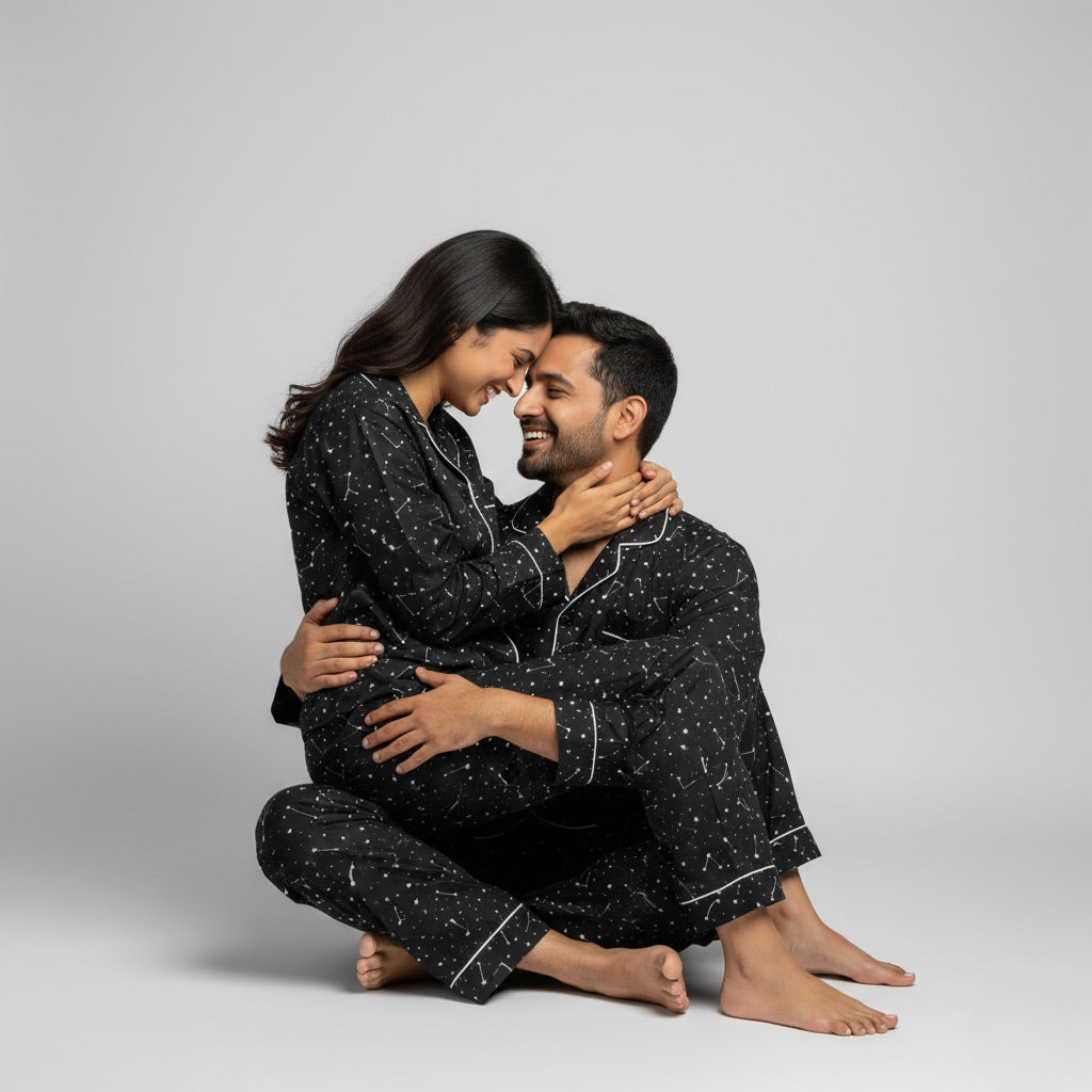 Couple in constellation print matching pajamas, starry coordinated nightwear.