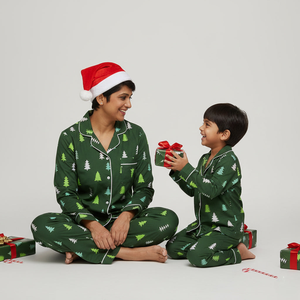 Mother and son in Evergreen Forest matching pajama set, rich green festive print.