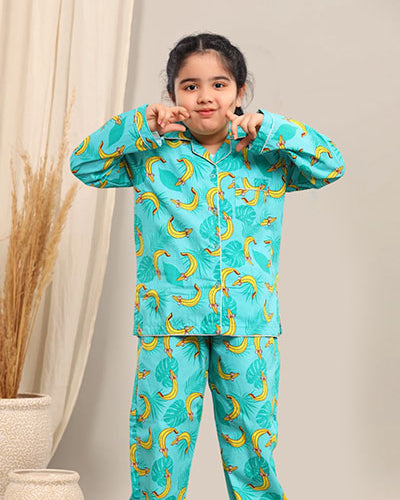 Child wearing a turquoise pyjama set against a neutral background