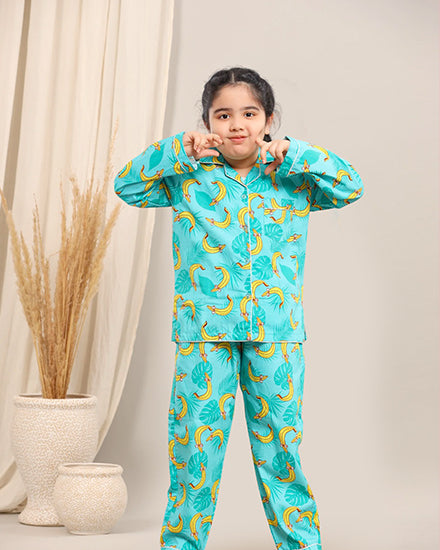 Child wearing a turquoise pyjama set against a neutral background