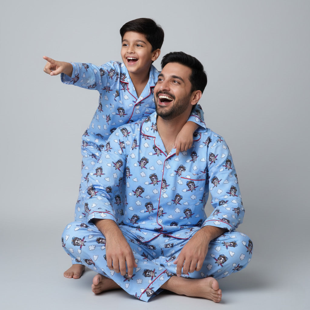 Father and son wearing glider print matching pajamas, aviation-themed coordinated design.