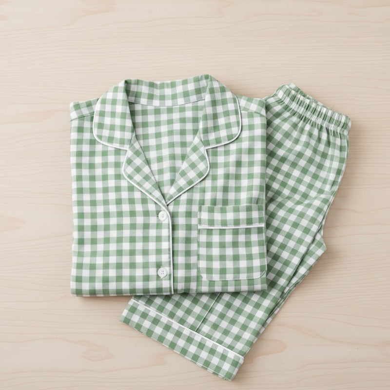 Green and white checkered pajama set on a beige surface