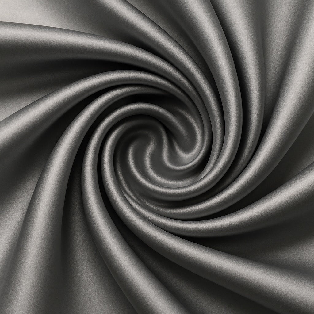Close-up of grey satin fabric with a swirling pattern