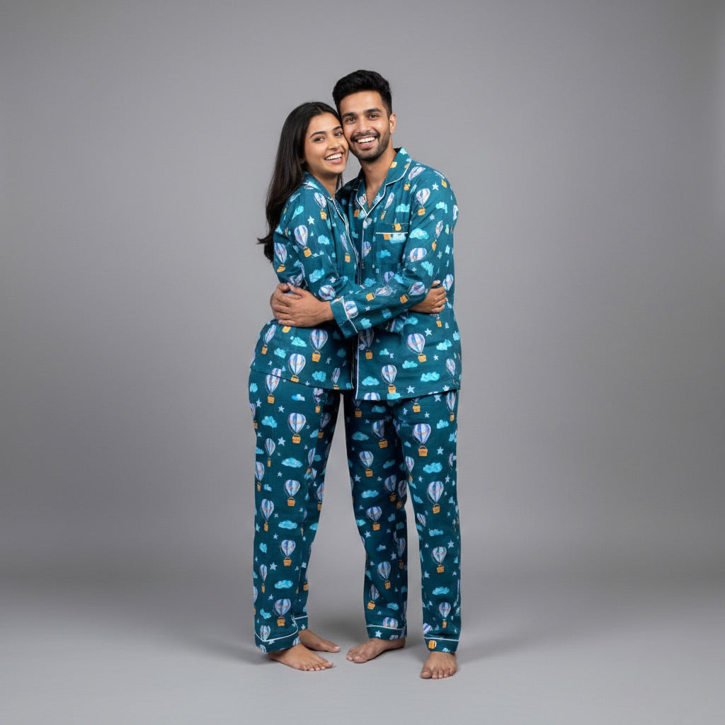 Couple wearing hot air balloon matching pajamas, whimsical coordinated print.