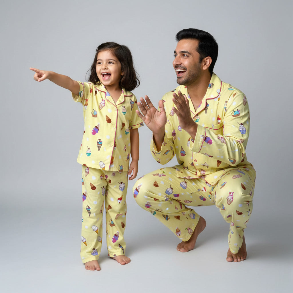 Father and daughter wearing ice cream cupcake print matching pajamas, sweet pastel coordinated set.