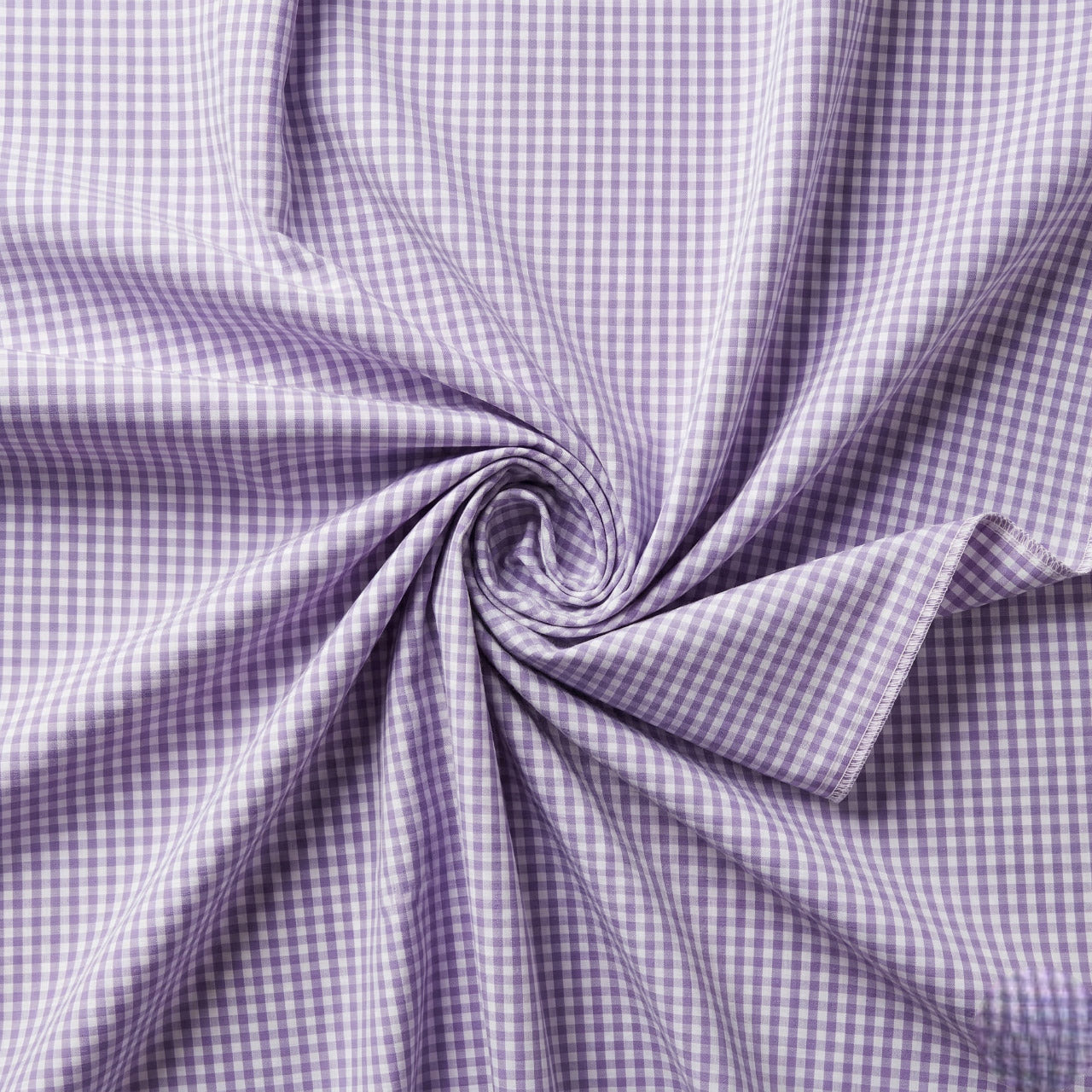 Close-up of purple and white checkered fabric with a swirl pattern.