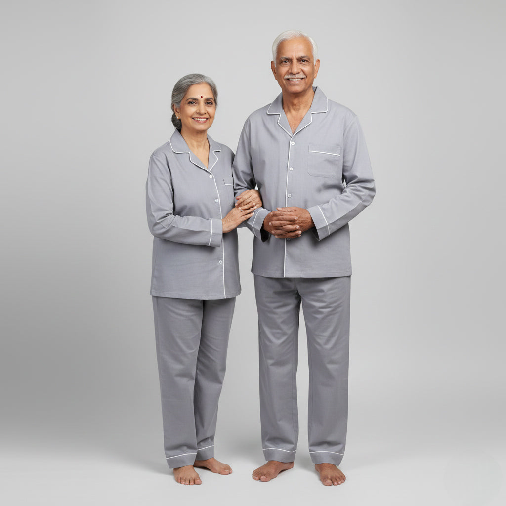 Elderly couple wearing light grey matching pajama set, minimal coordinated nightwear.