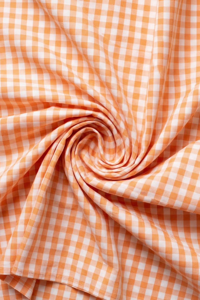 Close-up of orange and white checkered fabric in a swirl pattern