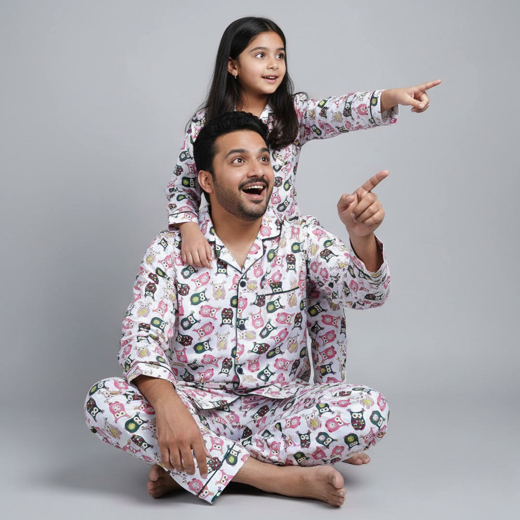 Father and daughter wearing owl print matching pajamas, soft coordinated design.
