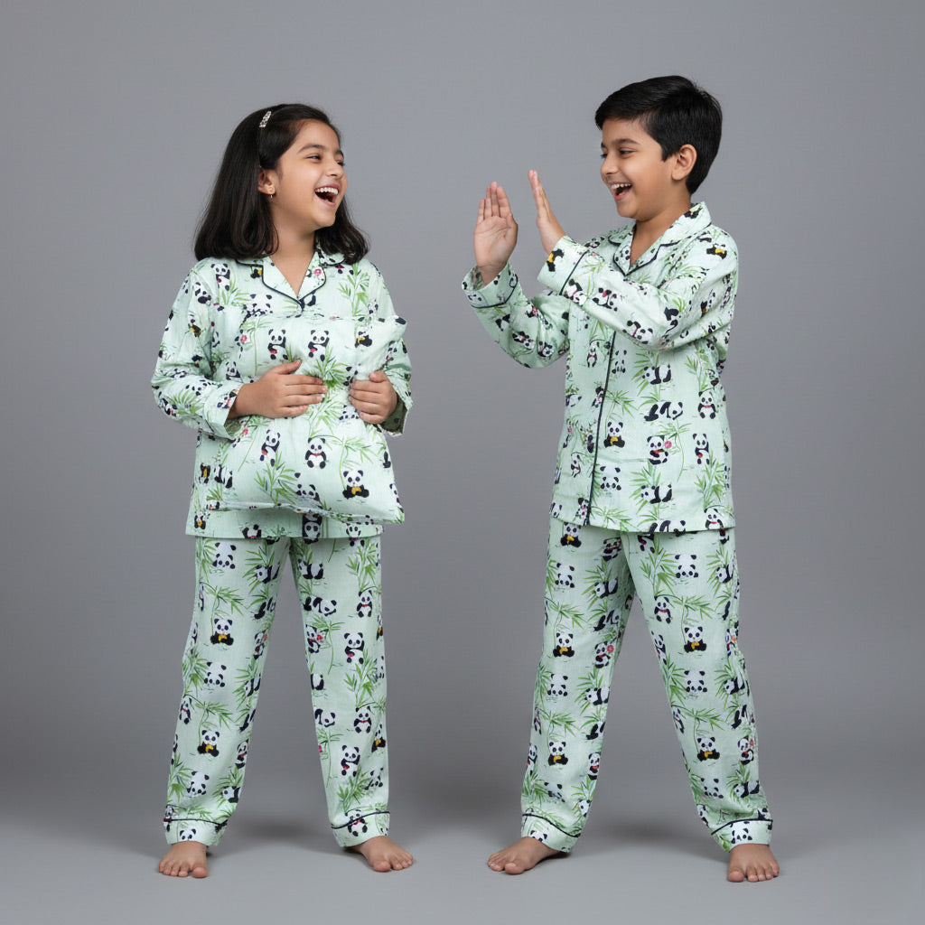 Siblings in panda print matching pajamas, cute black-and-white coordinated set.