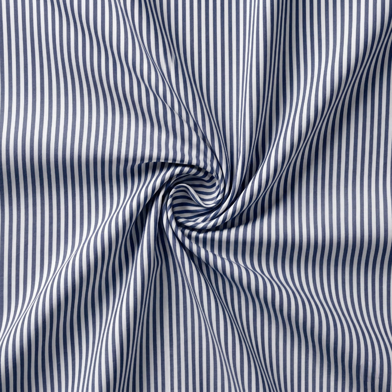 Close-up of blue and white striped fabric with a swirl pattern