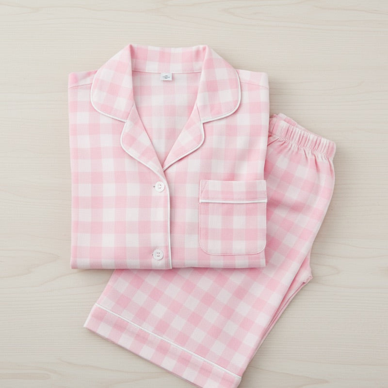 Pink and white checkered pajama set on a light beige background