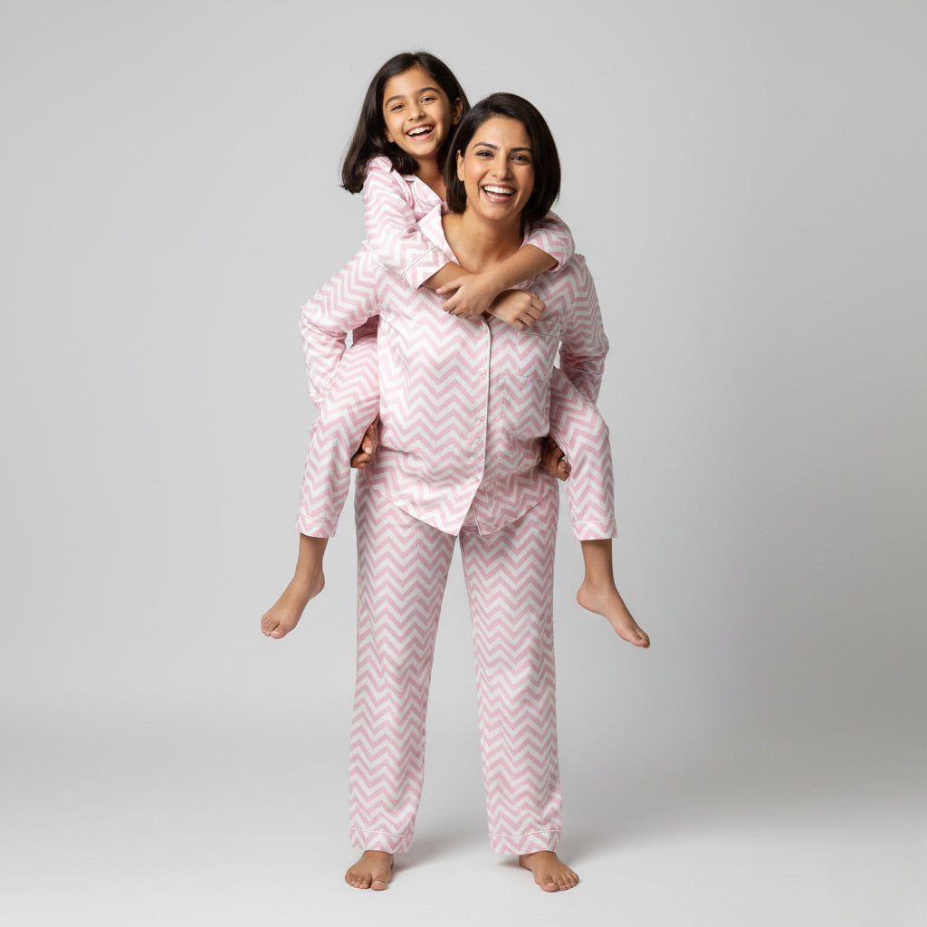 Mother and daughter wearing pink zig-zag matching pajamas, vibrant coordinated nightwear.