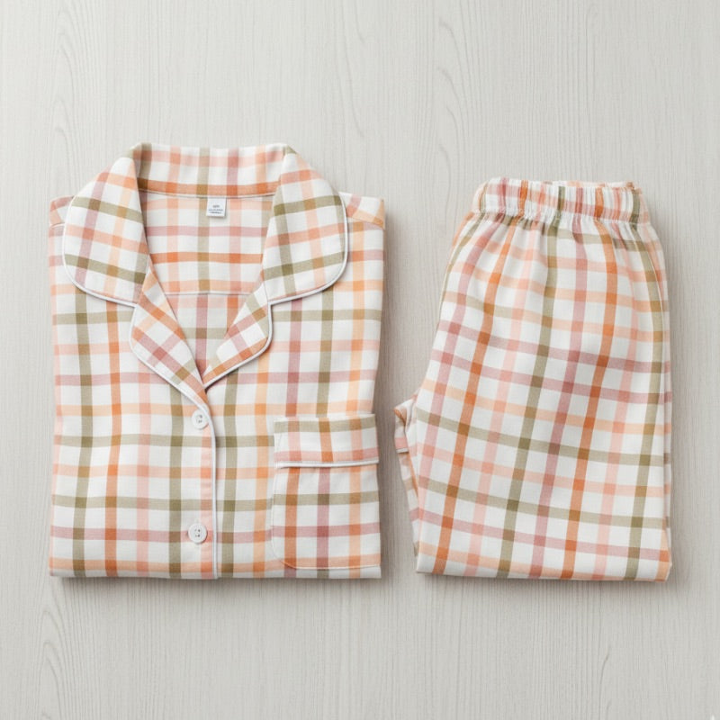 Plaid pajama set on a light wooden surface