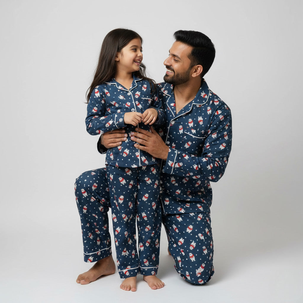 Father and daughter wearing polar bear print matching pajamas, cozy coordinated nightwear.