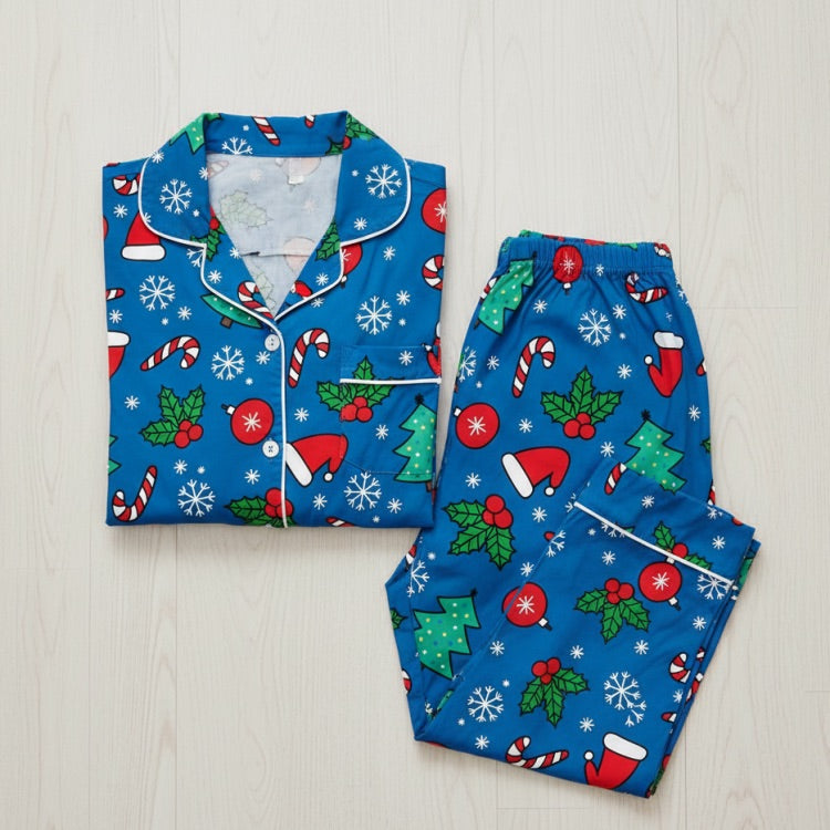 Blue Christmas-themed pajama set on a light wooden surface