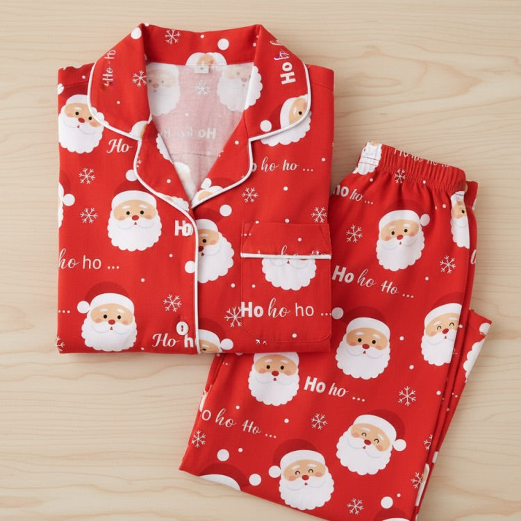 Red Christmas pajama set with Santa Claus pattern on a wooden surface