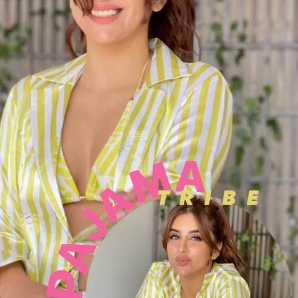 Woman wearing a yellow and white striped super soft satin night suit with 'Pajamatribe' branding.