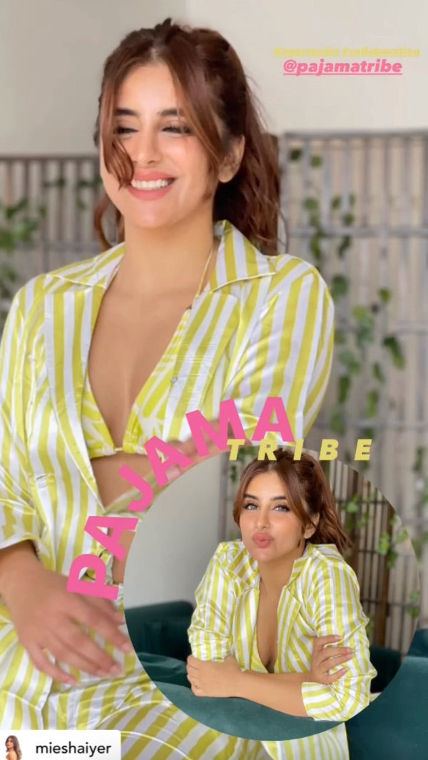 Woman wearing a yellow and white striped super soft satin night suit with 'Pajamatribe' branding.