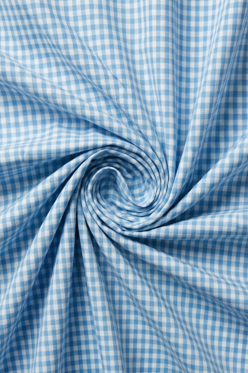 Blue and white checkered fabric in a swirl pattern