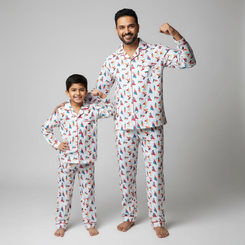 Father and son in superhero print matching pajamas, bold coordinated nightwear.