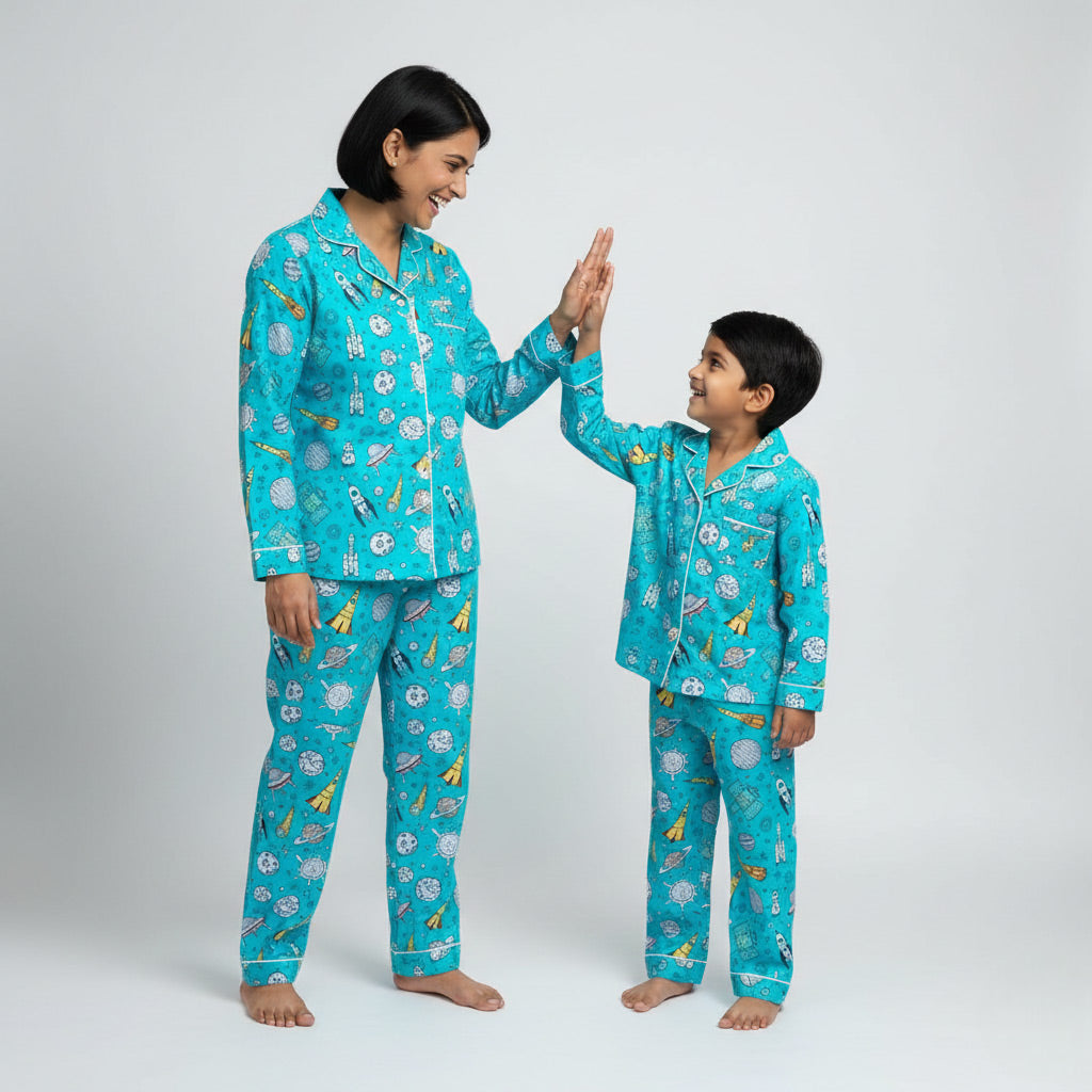 Mother and son wearing To the Moon matching pajamas, space-themed coordinated nightwear.