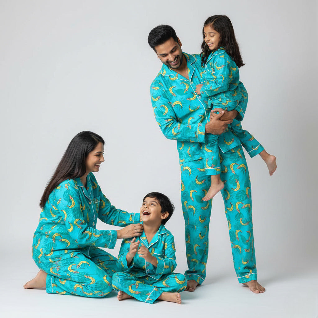 Family wearing tropical banana print matching pajama set, smiling together.