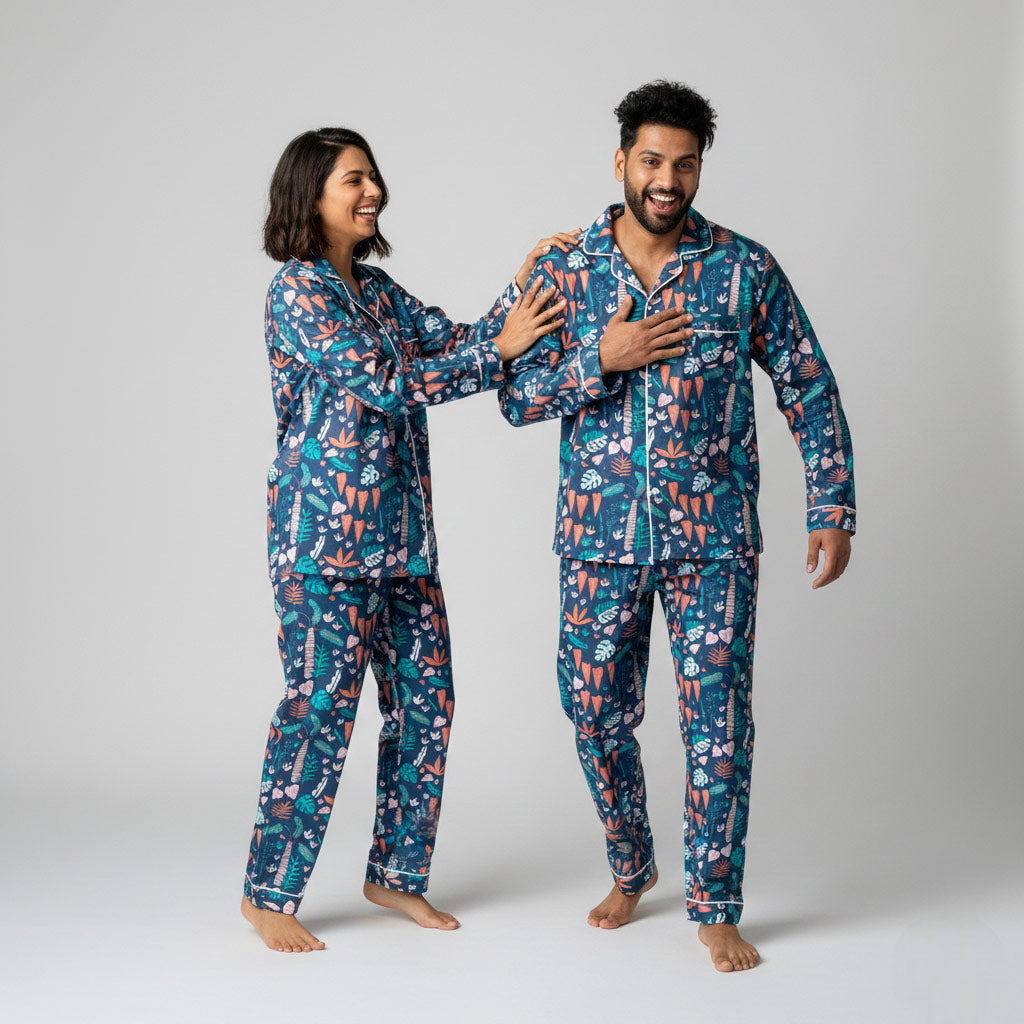 Couple wearing tropical foliage matching pajamas, leafy green coordinated design.