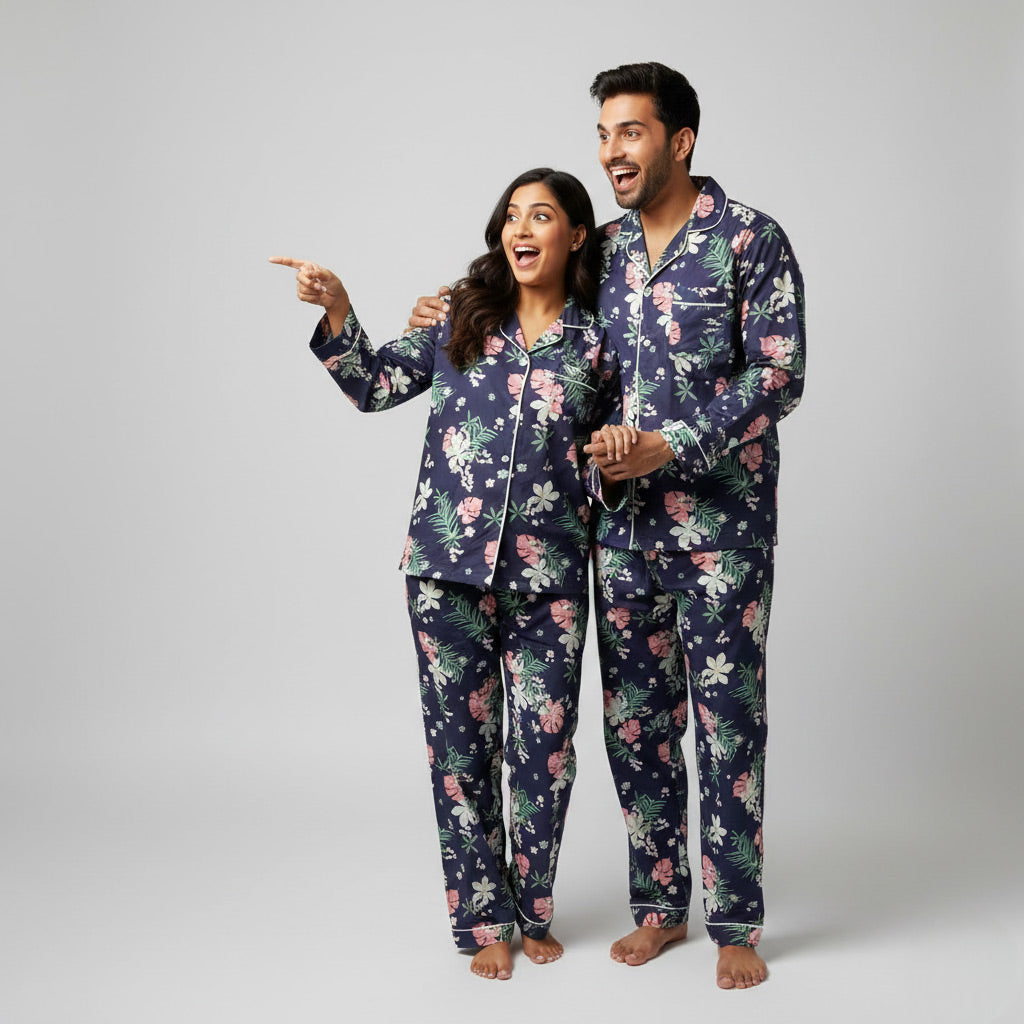 Couple wearing tropical scene matching pajama set, beach-inspired coordinated look.