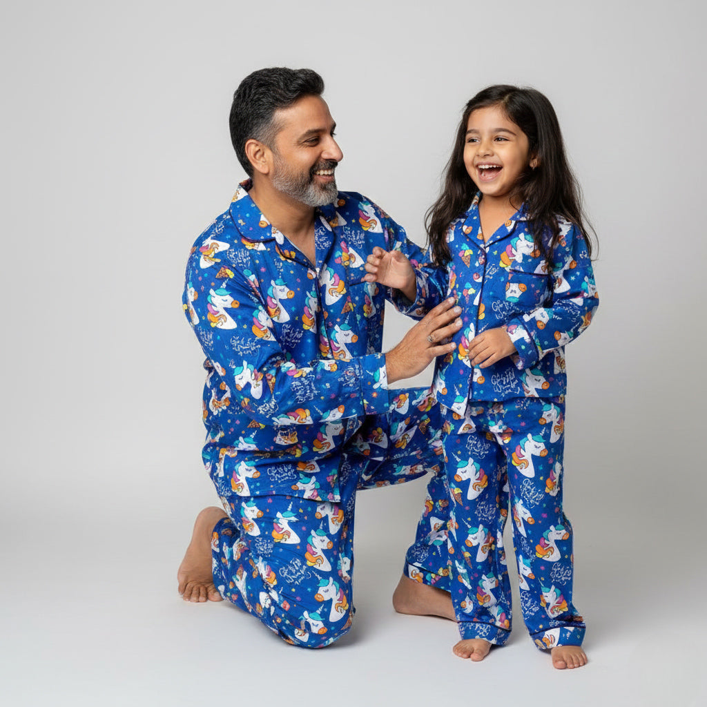 Father and daughter wearing Unicorn in Blue matching pajamas, soft blue coordinated print.