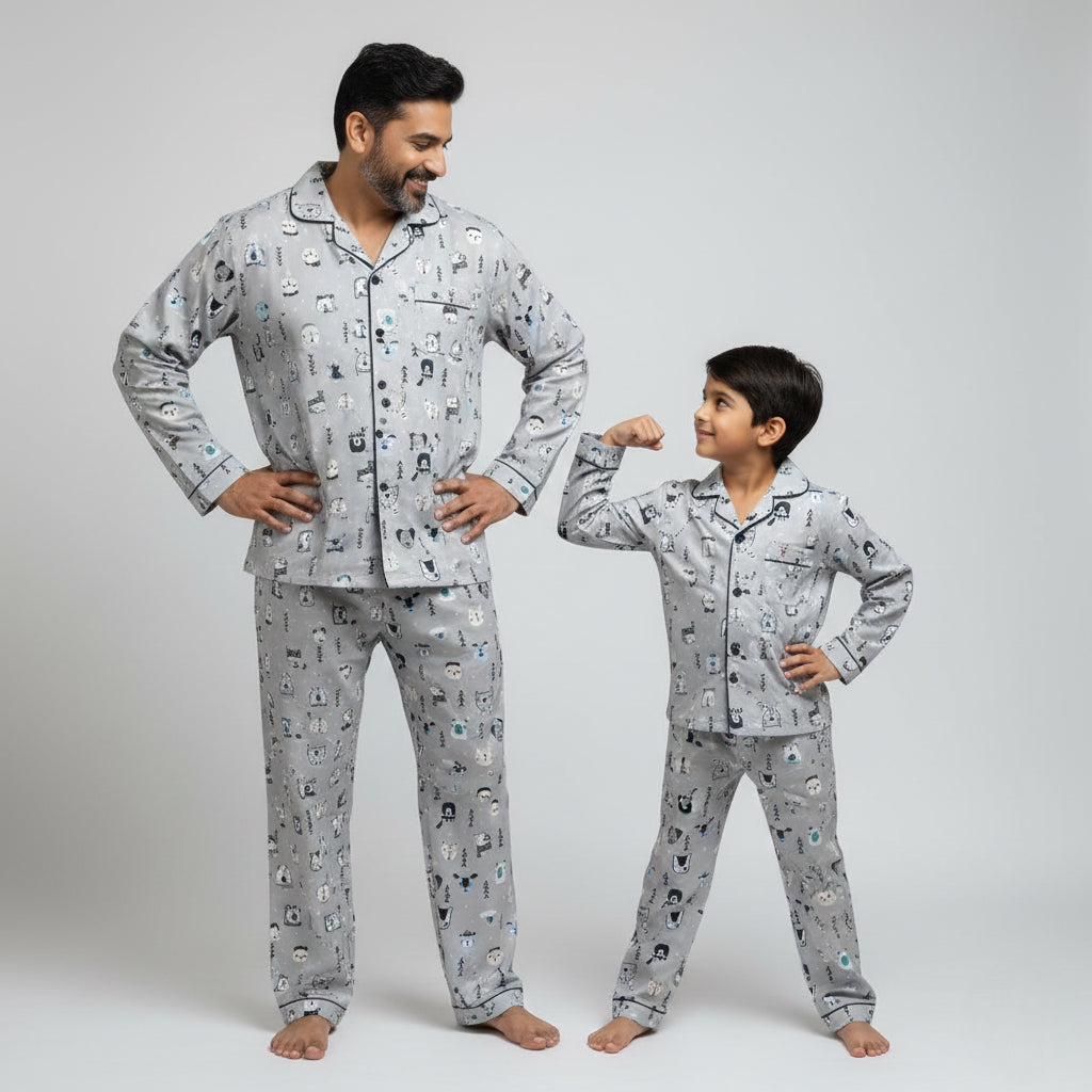 Father and son wearing white fox in snow matching pajama set, winter-inspired coordinated look.
