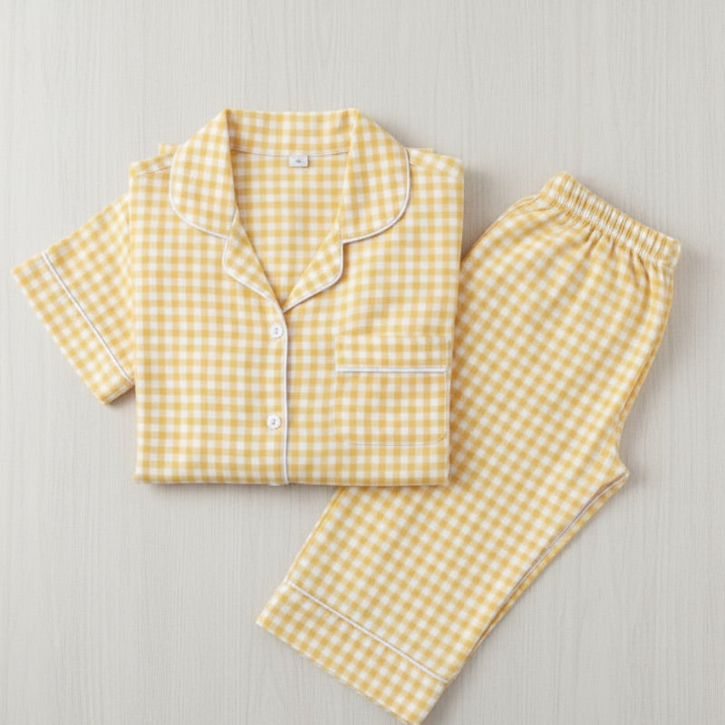 Yellow gingham pajama set on a light gray background