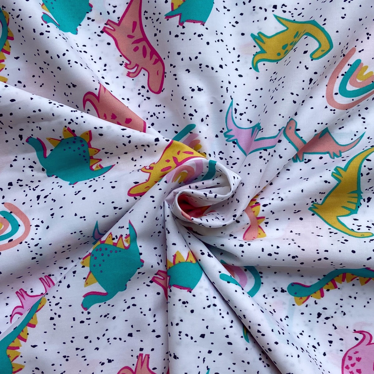 Dinosaur cotton fabric for dinosaur night suits, playful kids’ sleepwear and party pajamas.