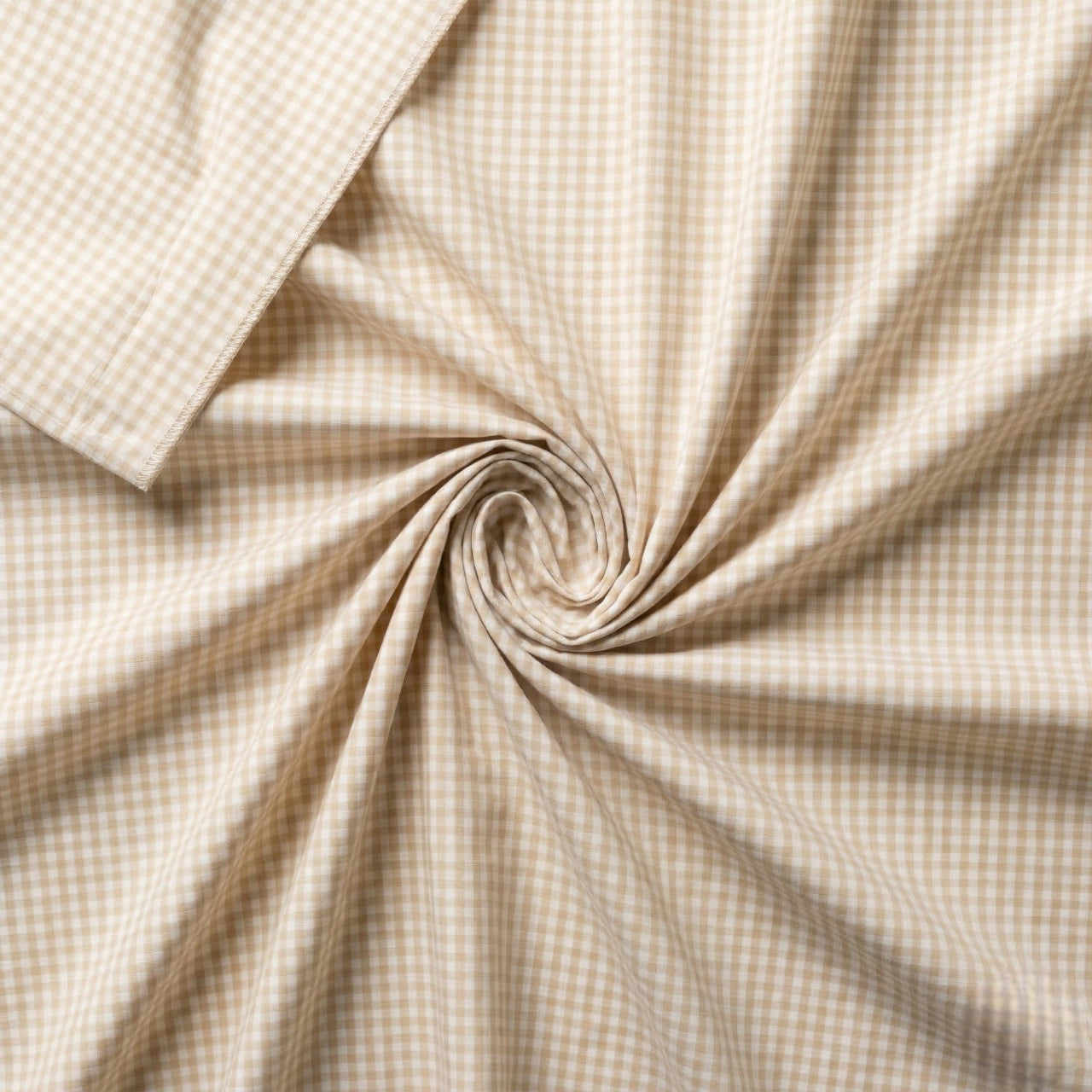 Close-up of beige checkered fabric with a swirl pattern