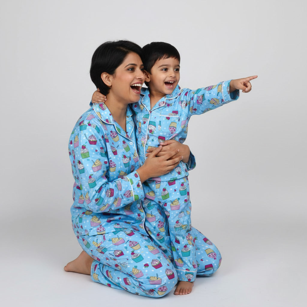 Mother and son in blue cupcake print matching pajamas, playful coordinated sleepwear.