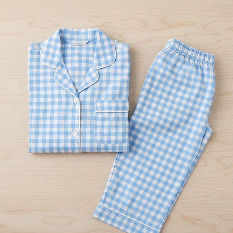Blue and white checkered pajama set on a wooden surface