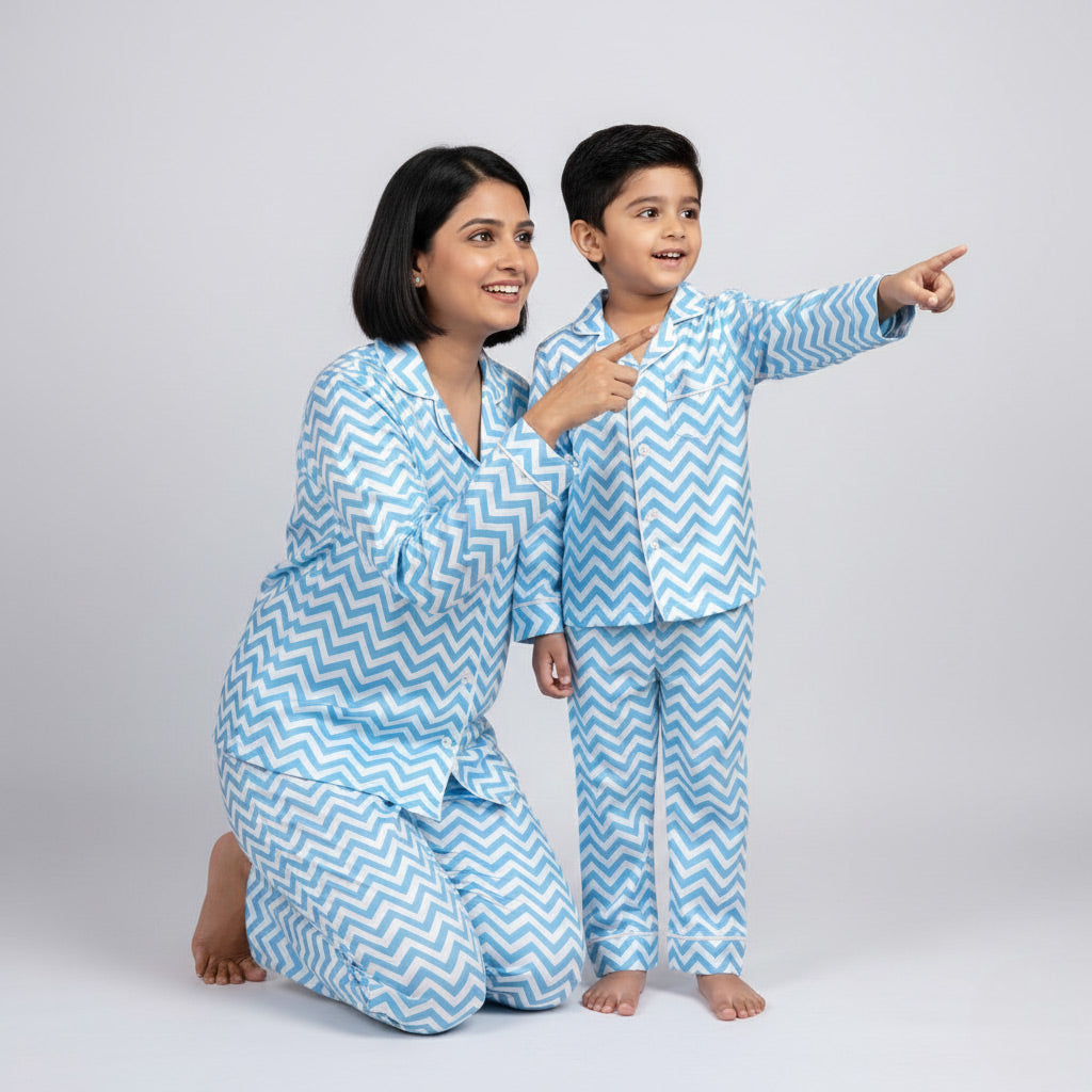 Mother and son wearing blue zig-zag matching pajamas, vibrant coordinated nightwear.