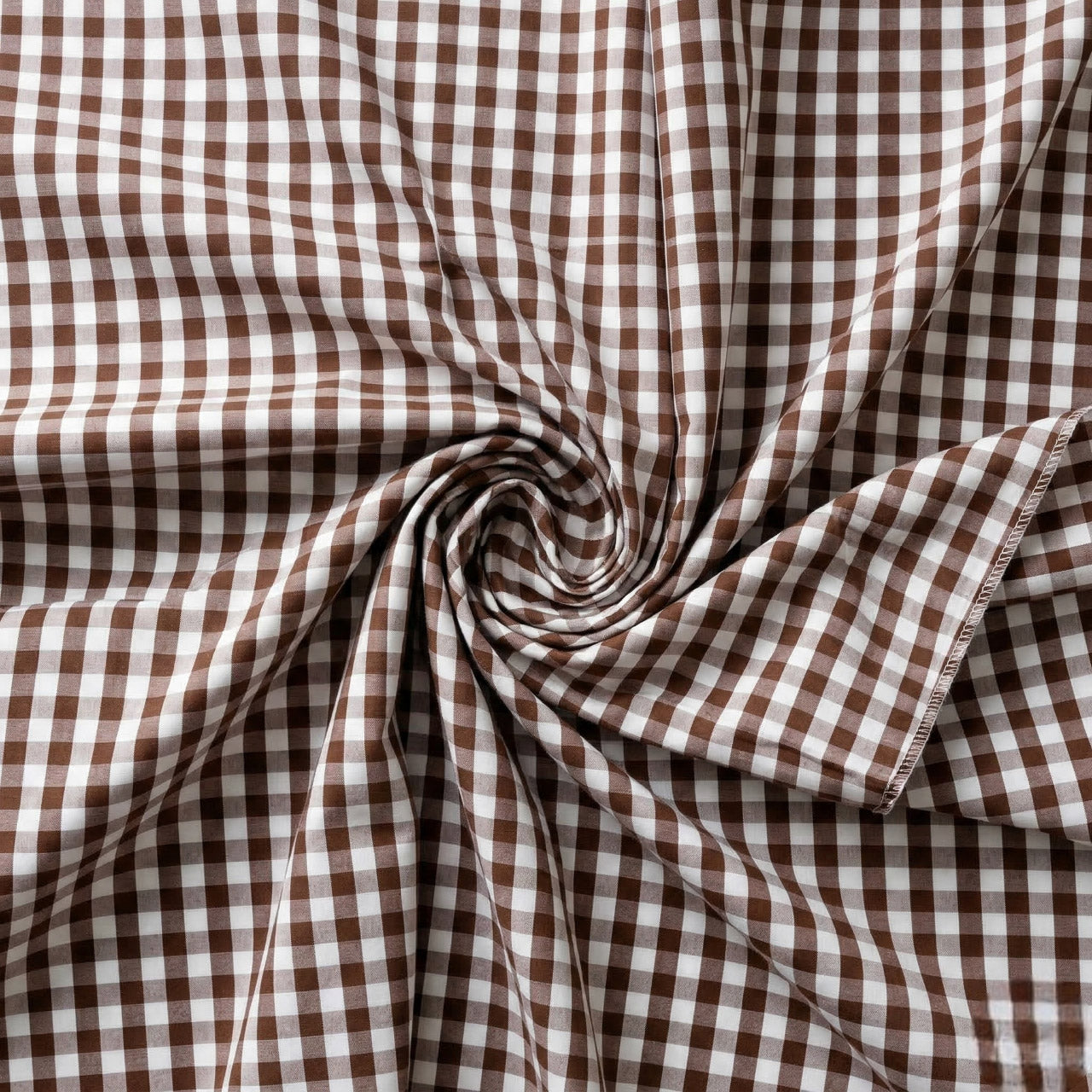Brown and white checkered fabric with a swirl pattern