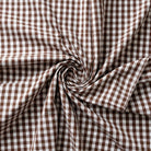 Brown and white checkered fabric with a swirl pattern