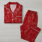 Red pajama set with Christmas patterns on a light wooden surface