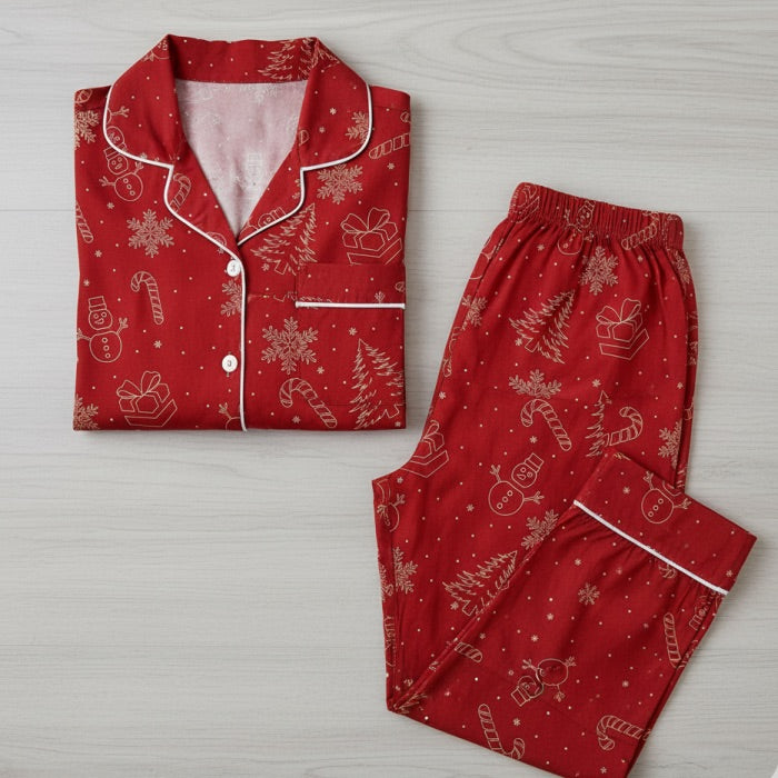 Red pajama set with Christmas patterns on a light wooden surface