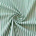 Green and white striped fabric in a swirl pattern