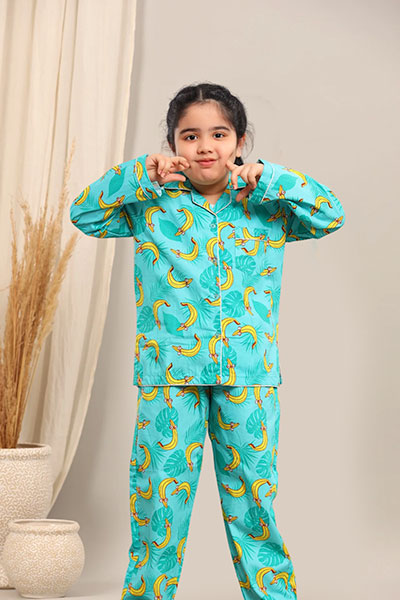 Child wearing a turquoise pyjama set against a neutral background